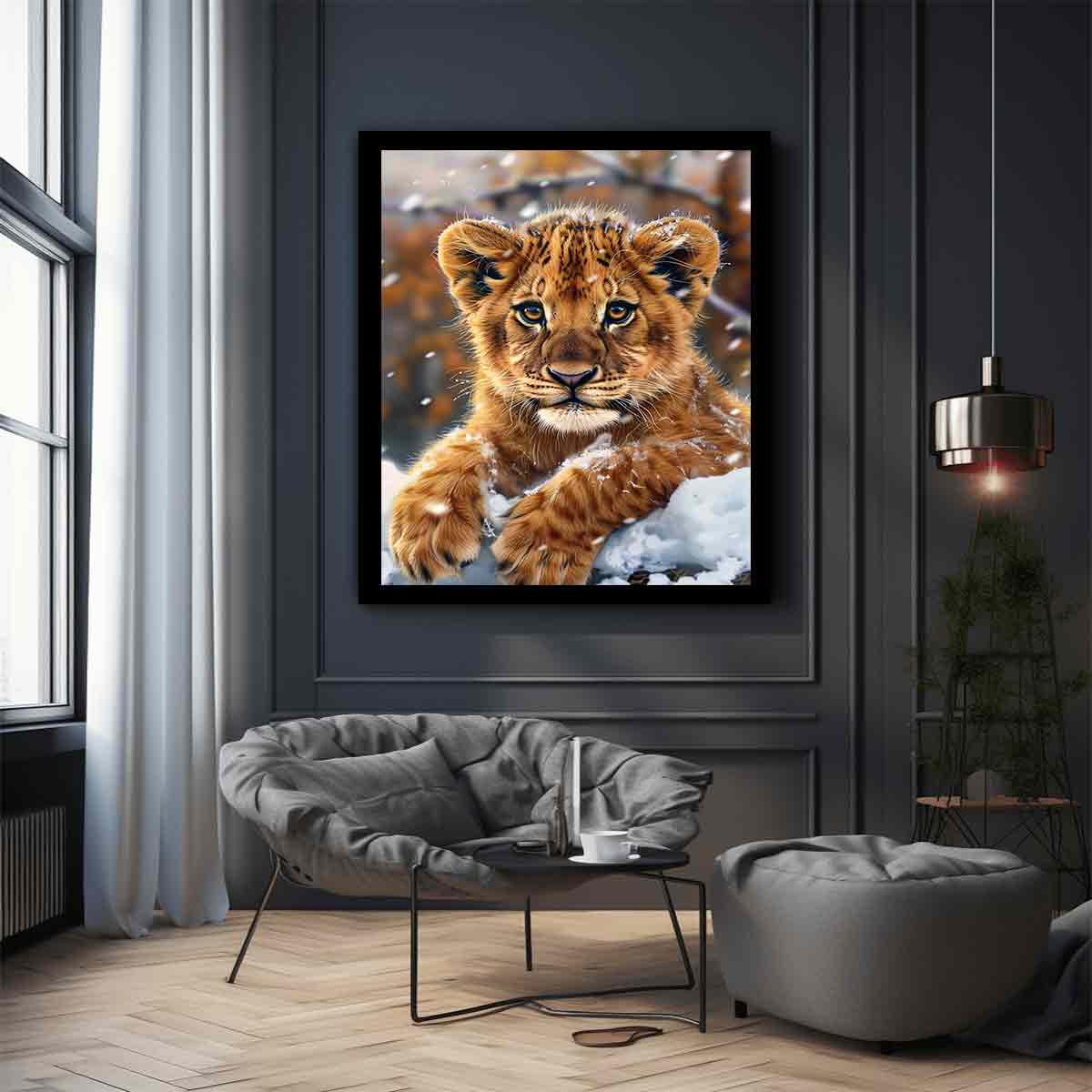 Young lion cub resting in snow with soft falling flakes for modern nurseries decor.